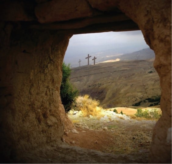 Empty tomb with three crosses in the background.